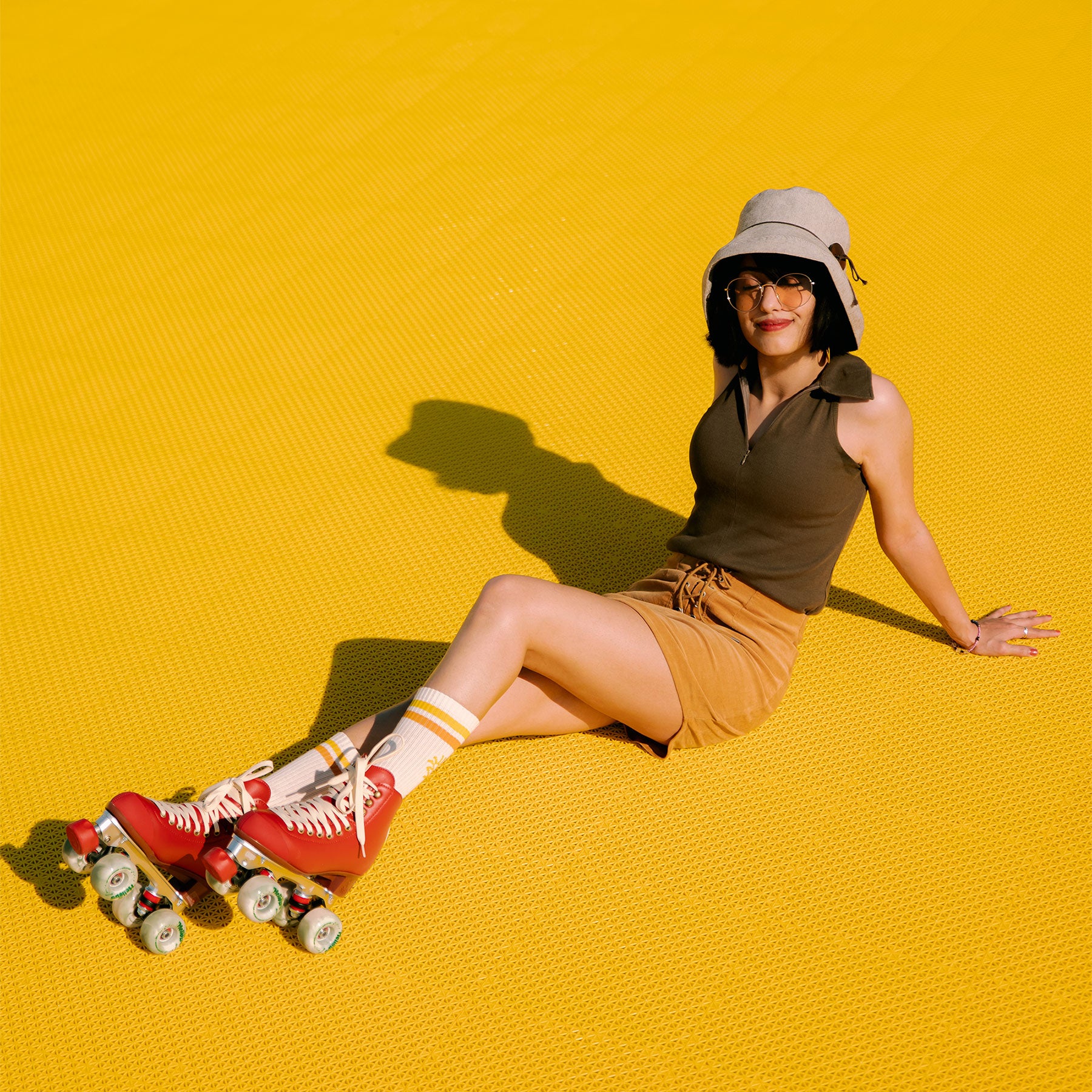 roller skate girl on a bright yellow tiled background